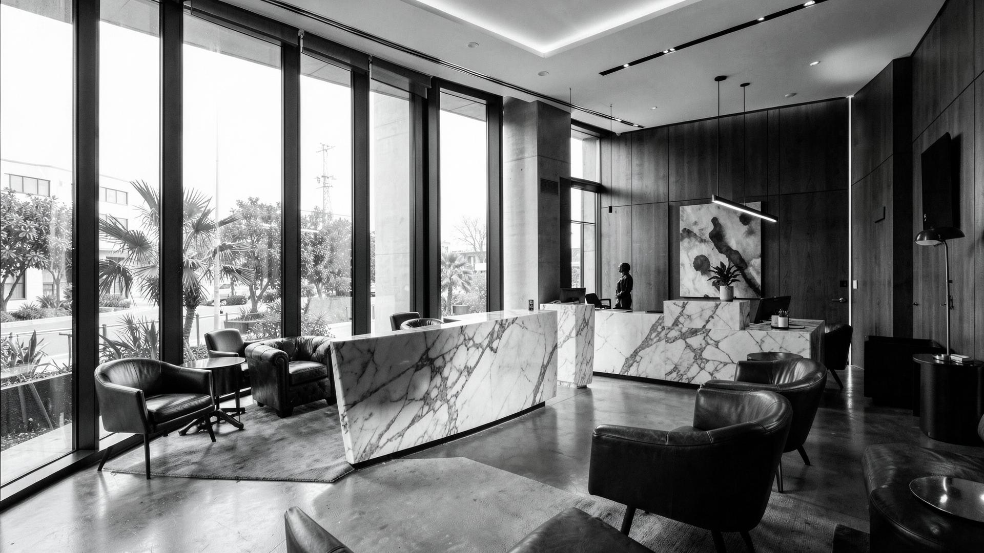 The Quarter reception lounge with marble desk and floor-to-ceiling windows